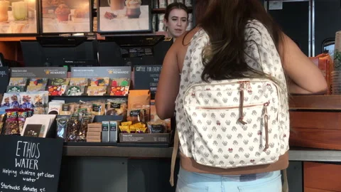 Motion of customer ordering coffee chatting inside Starbucks store Video stock 95617921