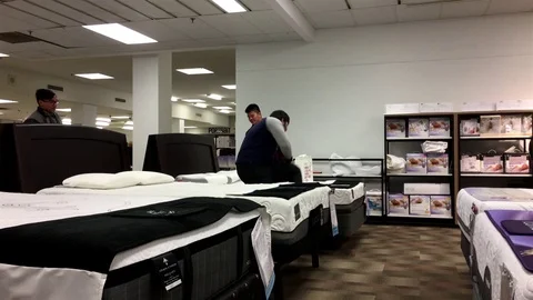 Motion of customer shopping mattress inside Sears store Stock Footage 71481203