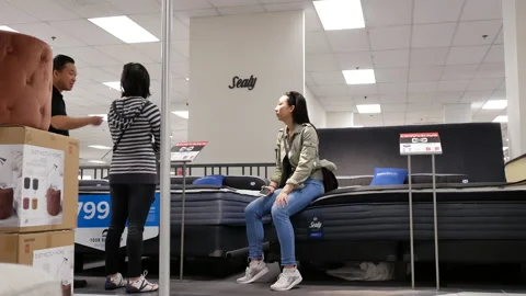 Motion of customer shopping mattress inside The Bay store with 4k resolution Video stock 89020530