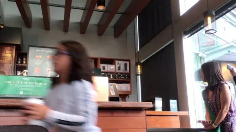 Motion of customer waiting for their coffee at Starbucks store Video stock 114880445