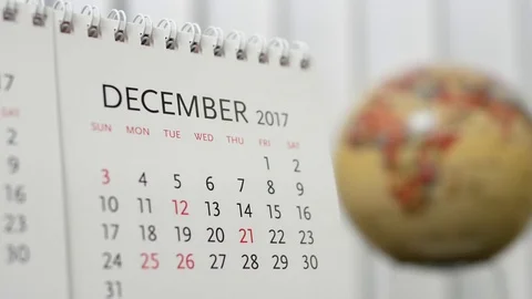 Motion of December 2017 calendar with blur earth globe turning background Stock Footage 70999634