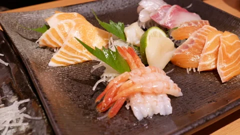 Motion of delicious plate of raw slice salmon and tuna sashimi Video stock 93626674