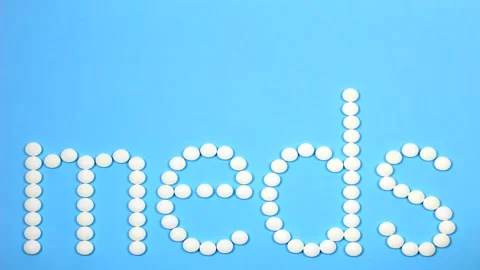 Motion Design. 4K Stop motion word text letters meds on blue background . Stock Footage 156298663