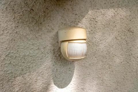 Motion detector on a house wall for quick light adjustment Stock Photos