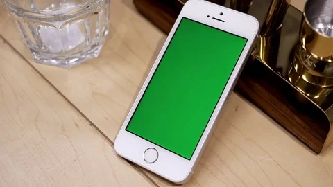 Motion of display tableware and green screen phone on table with 4k resolution Video stock 76240915