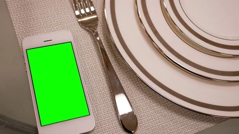 Motion of display tableware and green screen phone on plate 스톡 동영상 76581928