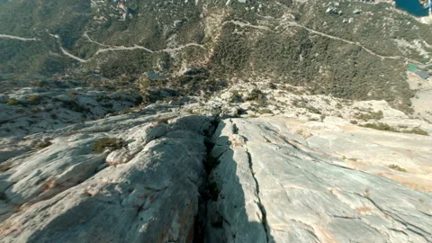 Motion down along mount Kush-Kaya to pine forest and town Stock Footage 141668524