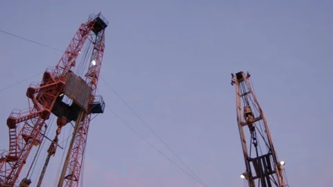 Motion down from Tower Crane Top to Pipe Pile and Workers Stock Footage 79208814