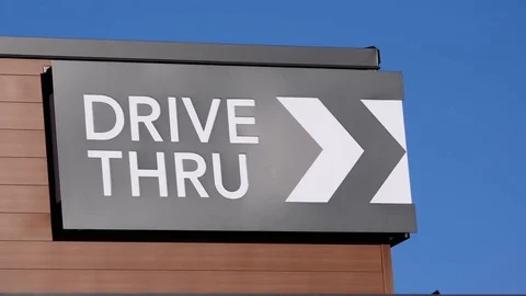 Motion of drive thru on building with blue sky background Stock Footage