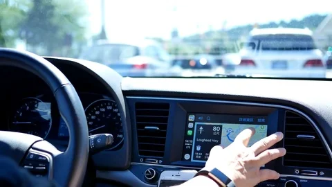 Motion of driver tapping GPS navigation on dashboard while driving on road Stock Footage 78414123