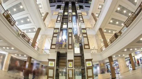 Motion elevators at the modern shopping mall timelapse hyperlapse. Stock Photos
