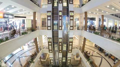 Motion elevators at the modern shopping mall timelapse hyperlapse. Stock Photos