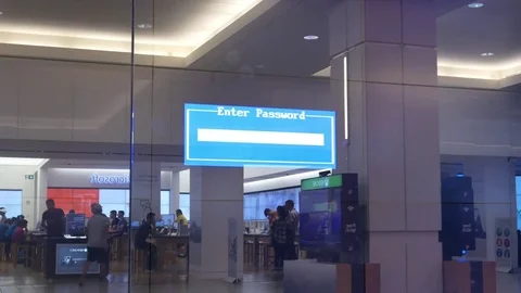 Motion of enter password reflection on display window beside Microsoft store Video stock 79055543
