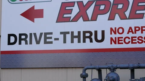 Motion of express line and drive thru sign on wall at Canadian tire store Stock Footage 102294818