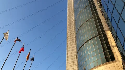 Motion of flying flags in front of shopping mall Stock Footage 100342888