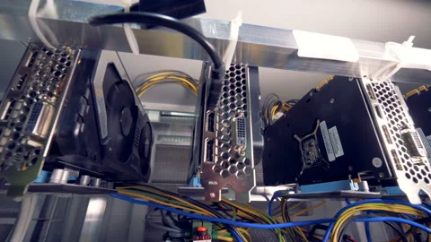 Motion footage of bitcoin mining process held by a row of graphic processing Stock Footage 88648835