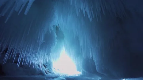 Motion forward inside icy frozen cave sharp icicles ceiling Lake Baikal landmark Video stock 165664042
