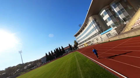 Motion FPV view in stadium. Professional fast sprint runner running on the Stock Footage 167927459