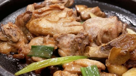 Motion of fried chicken with ginger and green onion on table Stock Footage 82956393