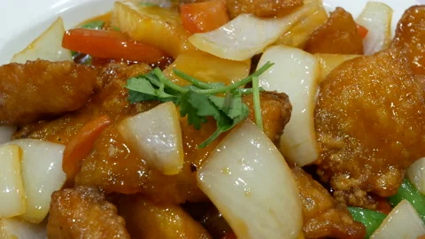The motion of fried pork and onion on a plate with steam Stock Footage 167498463