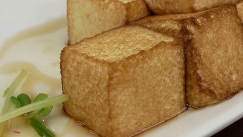 Motion of fried tofu on table inside restaurant with 4k resolution. Video stock 82634673
