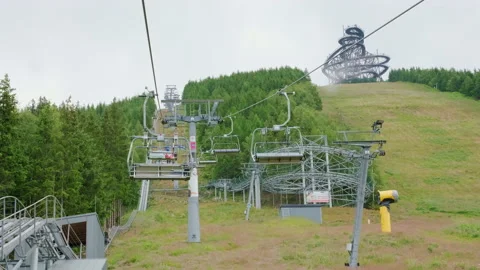 Motion of functioning chairlift chairs going to Sky Walk Stock Footage 203561759