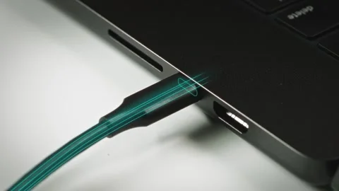 Motion graphics of USB-C cable insertion with animated data streams visualizing Stock Footage 315446902