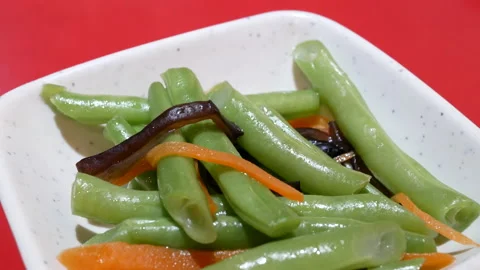 Motion of green bean on table inside Chinese restaurant Stock Footage 98766781
