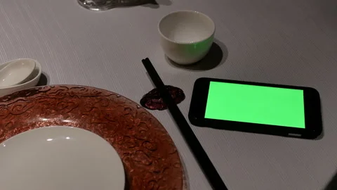 Motion of green screen phone and empty plate on table Stock Footage 99013922