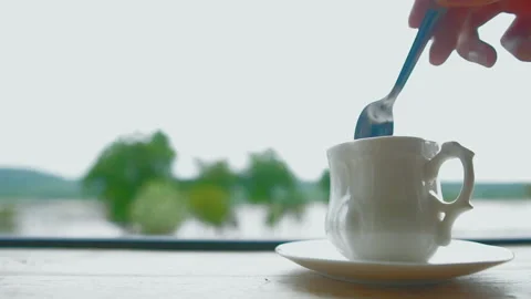 Motion hand of men using spoon to mix the coffee in the white cup. Stock Footage 156381874