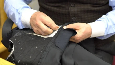 Motion of a hand of a tailor who sews with a needle Stock Footage 86000551
