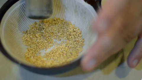 Motion of hand while mashing sesame inside bowl in Japanese traditional style Stock Footage 125168519