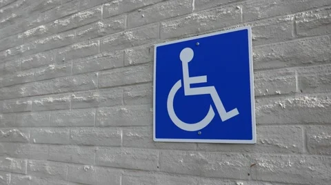 Motion of handicapped parking sign on wall Stock Footage 64981205