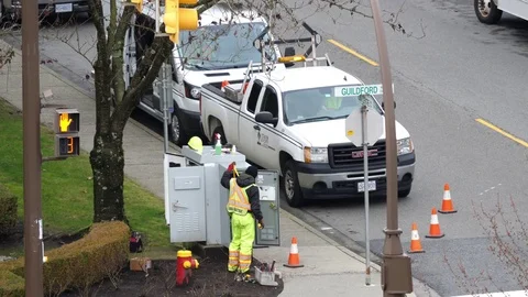 Motion of hydro worker repairing electricity issues on a street Stock Footage 85404403