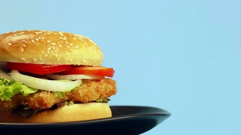 Motion Isolated hamburger rotates on table wood background, Rotating - fast Stock Footage 336579033