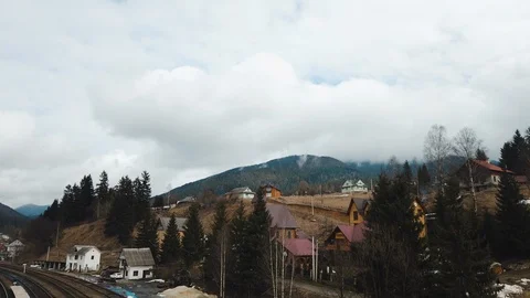 Motion lapse of arriving train at the mountain terrain. View from a bridge under Stock Footage 126010633