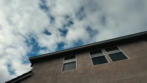 Motion lapse of clouds over a house Stock Footage 280319026
