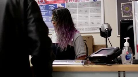 Motion of man asking about postage at post office inside shoppers drug mart Stock Footage 74513485