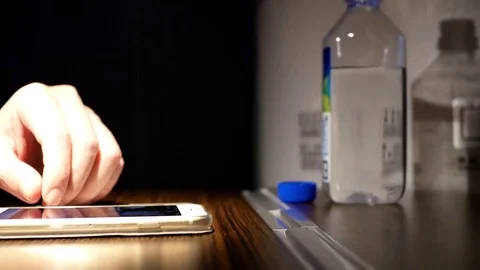 Motion of man browsing screen on smart phone and drinking water 스톡 동영상 85039133