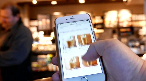Motion of man browsing Starbucks drink menu on phone Stock-Footage 67493138