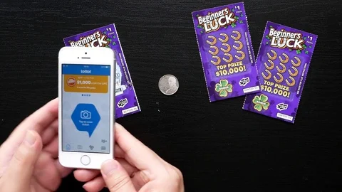 Motion of man checking lottery ticket by app with 4k resolution Stock Footage 76601606