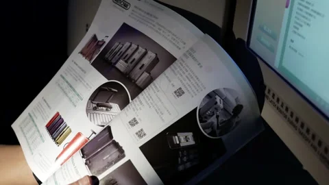The motion of a man finds a gift in the catalog on the airplane 스톡 동영상 242458270