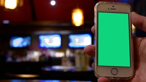 Motion of man holding green screen phone with blur worker working at bar 스톡 동영상 84872396