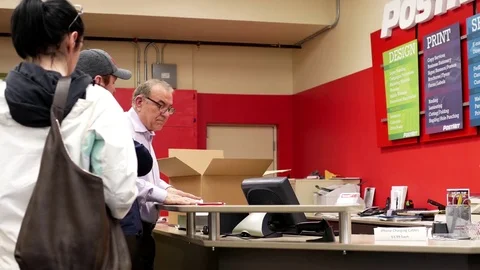 Motion of man mailing parcel at post office inside postnet express office Stock Footage 74715893
