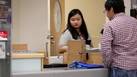 Motion of man mailing parcel at post office inside shopper drug mart store Stock Footage 76426864
