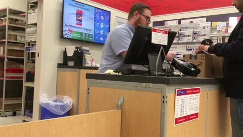 Motion of man mailing parcel at post office inside shopper drug mart store 스톡 동영상 97719816