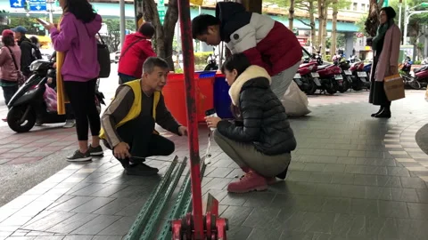 The motion of man measuring rebar size with commuters and passing by road Video stock 167023726