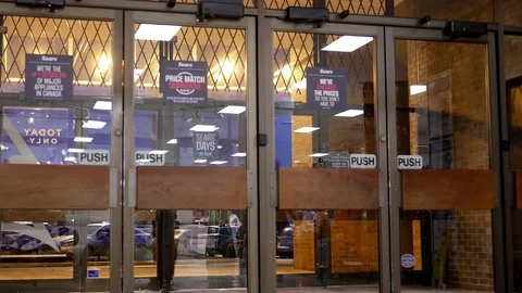 Motion of man opening door and walking through Sears store entrance 스톡 동영상 70222255