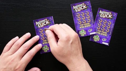 Motion of man scratching lottery ticket. Video stock 76628683