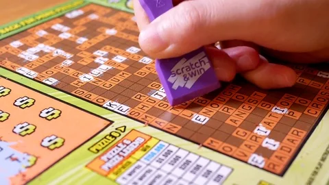 Motion of man scratching lottery ticket with 4k resolution. Video stock 78579517